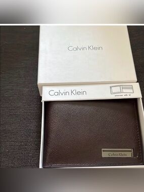 Calvin Klein Dark Brown Textured Leather Bi-Fold Wallet with Metal Nameplate